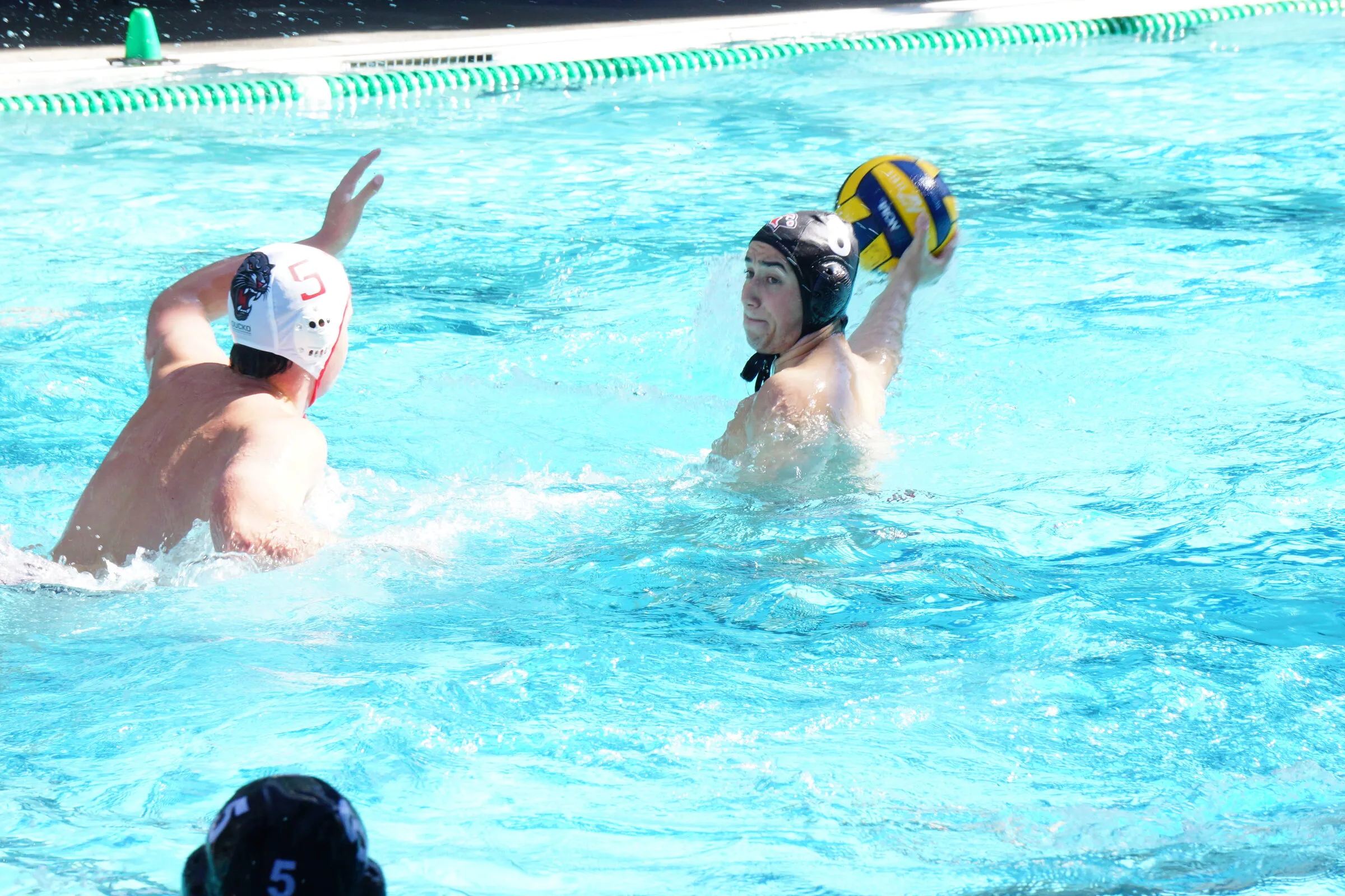 Two players contest the ball in open water