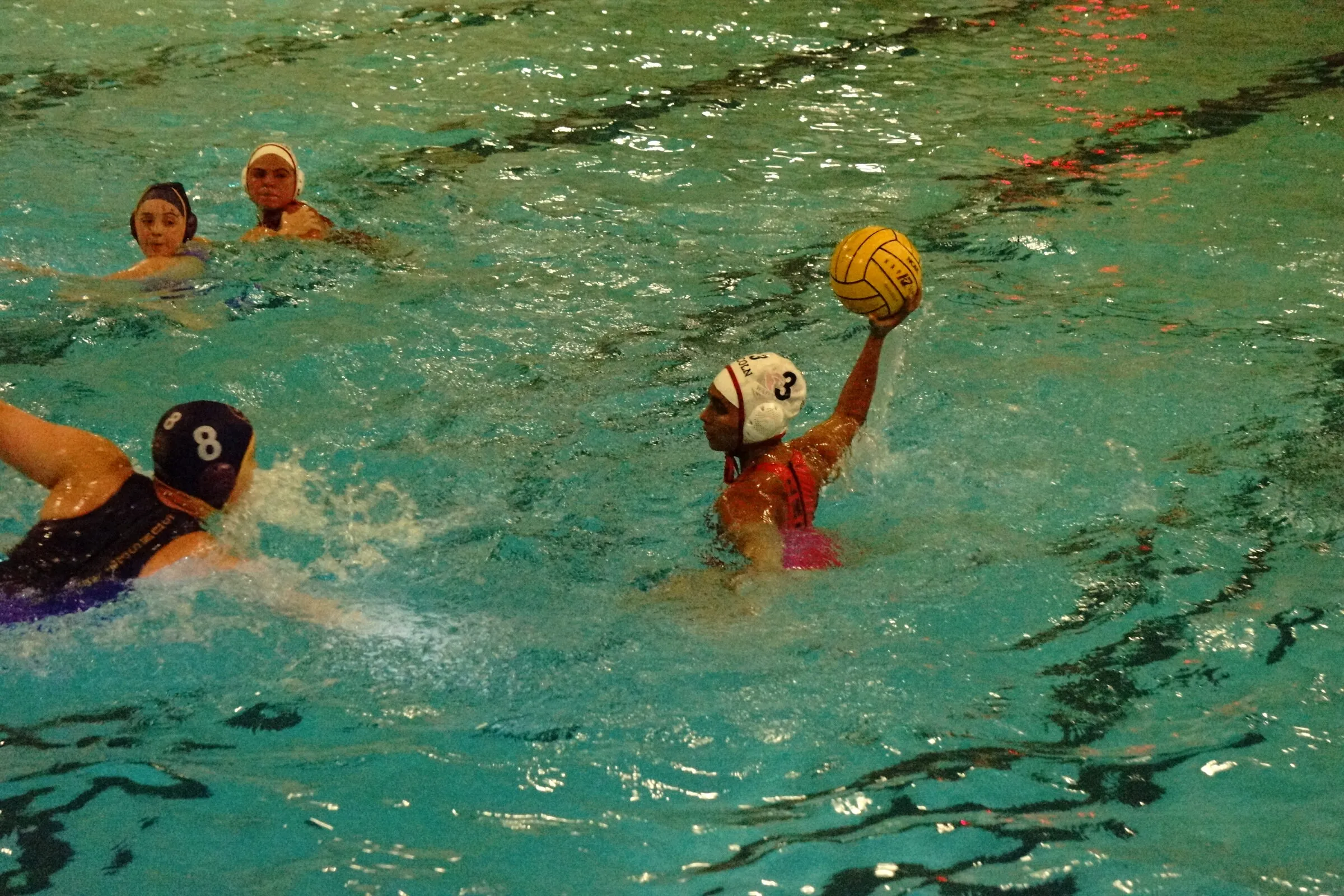 A player shoots in an outdoor pool