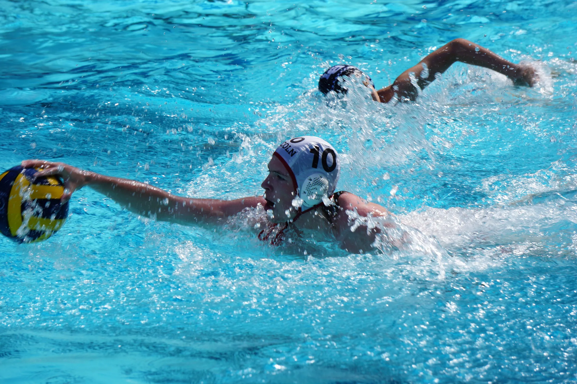 A player swims the ball up the pool