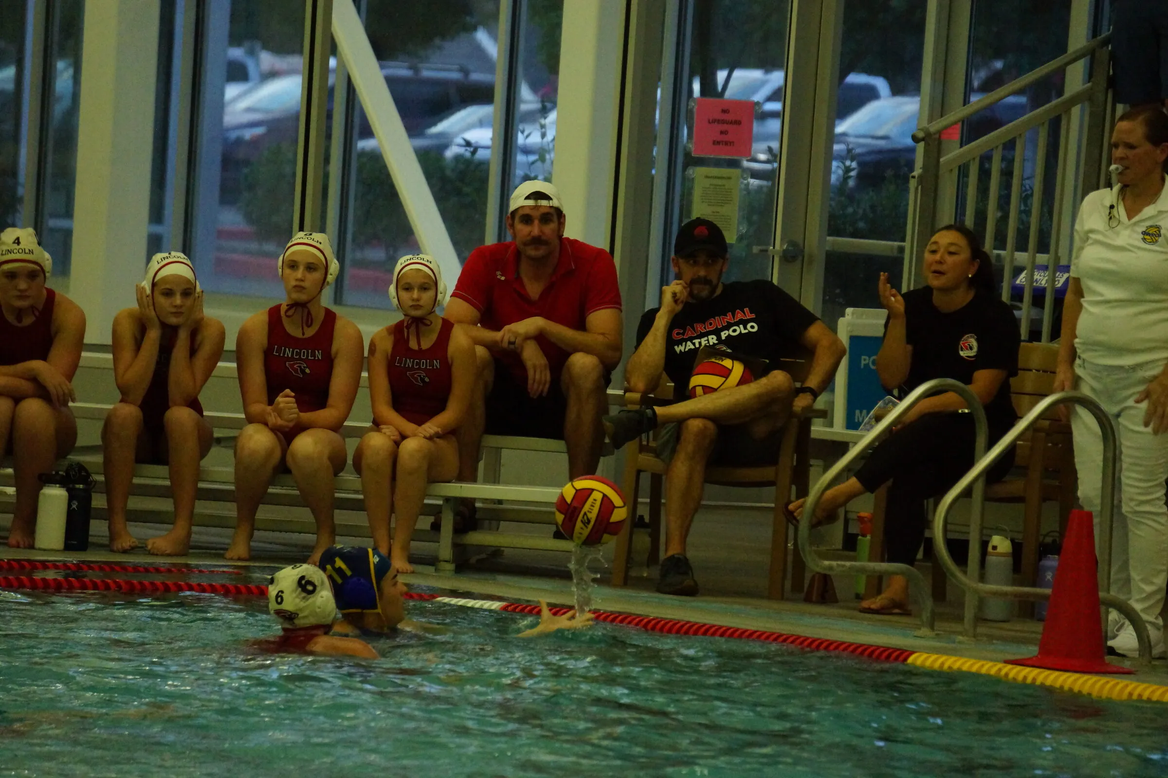 Players and coaches watch from the bench