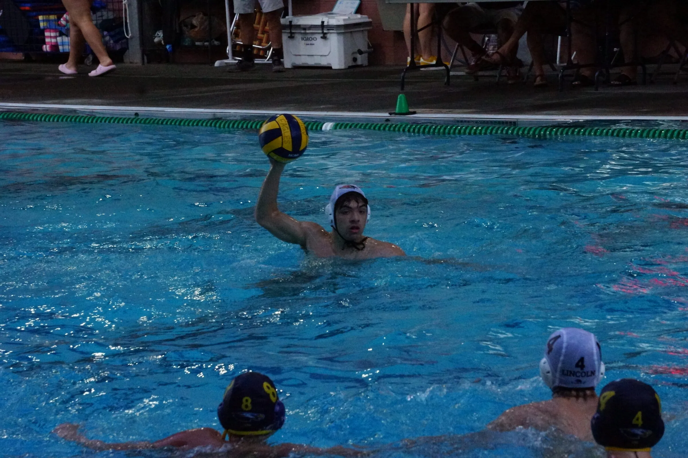 A player winds up to shoot in front of the bleachers